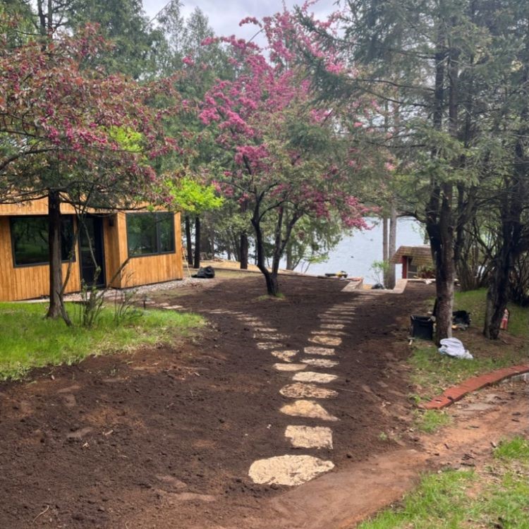 stone pathway to a lake and a cabin